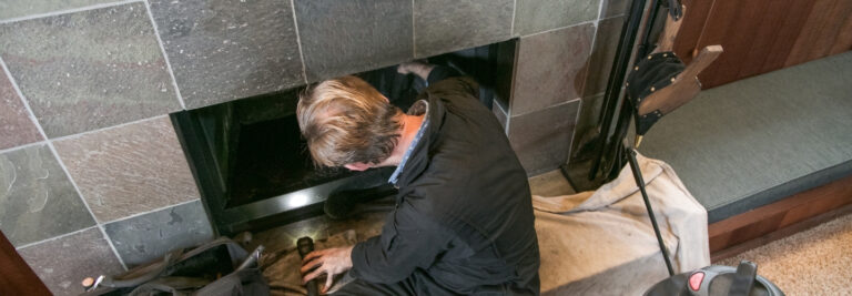 Chimney sweep looking at a chimney blockage